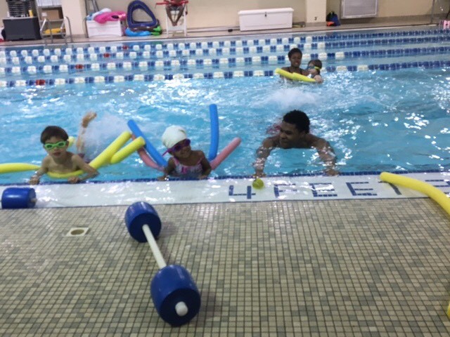 Kieley, and Ezra working on flutter kick with flotation devises.