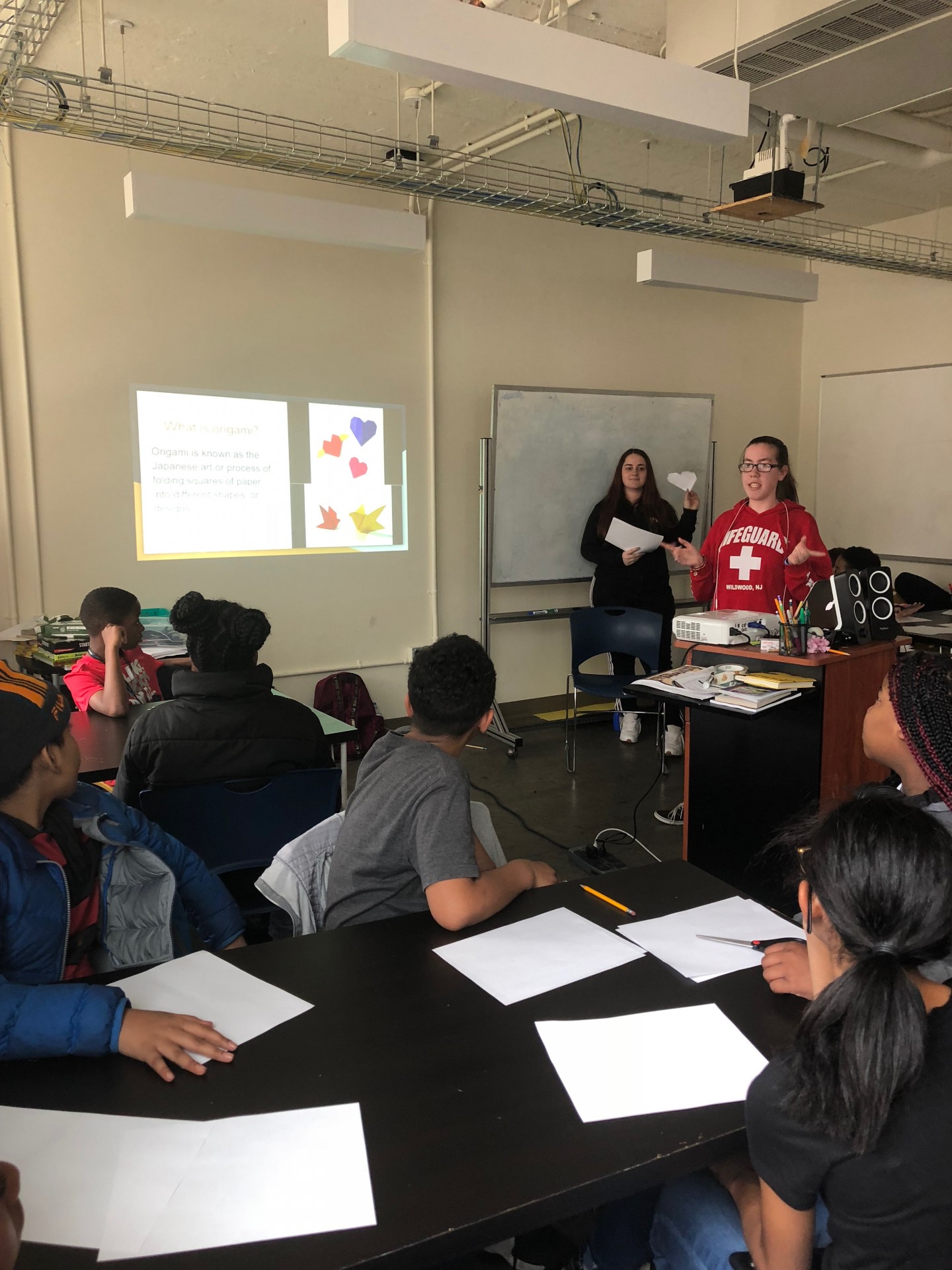 Stephanie & Mercedes teaching Ms.Hamilton’s class at Science Leadership Academy Middle School an origami lesson.